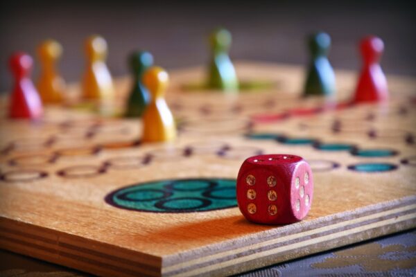 Colorful wooden board game with dice and player pawns, ideal for casual entertainment, parties, and fun game nights with friends and family.