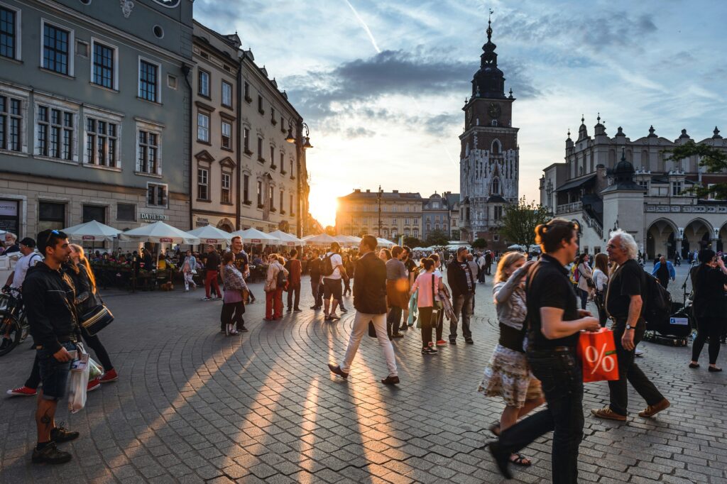 ludzie chodzący po krakowskim rynku
